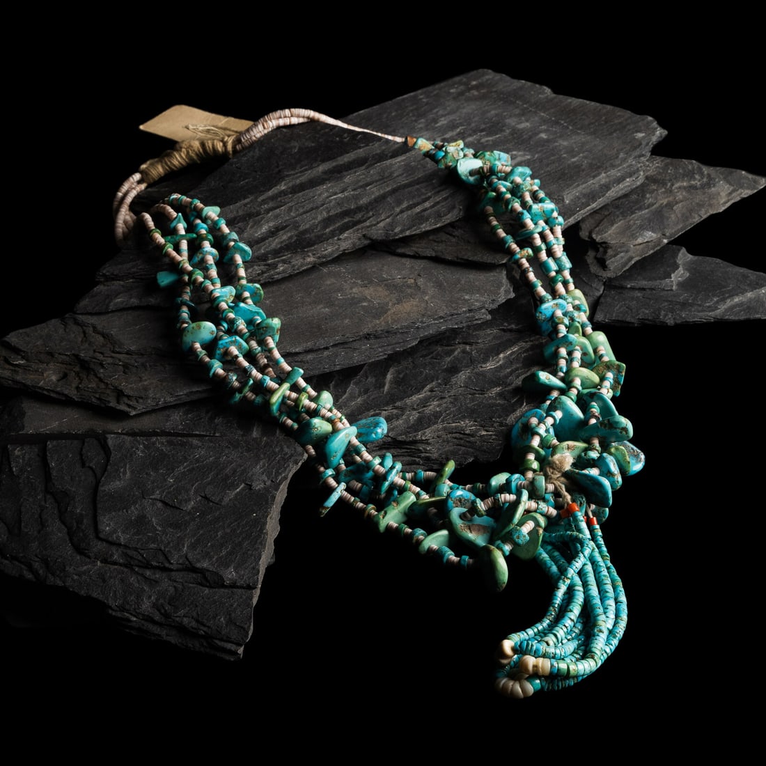 Pueblo Multi-strand Turquoise Tab Necklace: Pueblo Multi-strand Turquoise Tab Necklace mid-20th century four-strand necklace strung with heishi and graduated turquoise tabs; with four graduated rolled turquoise and shell joclas; not marked