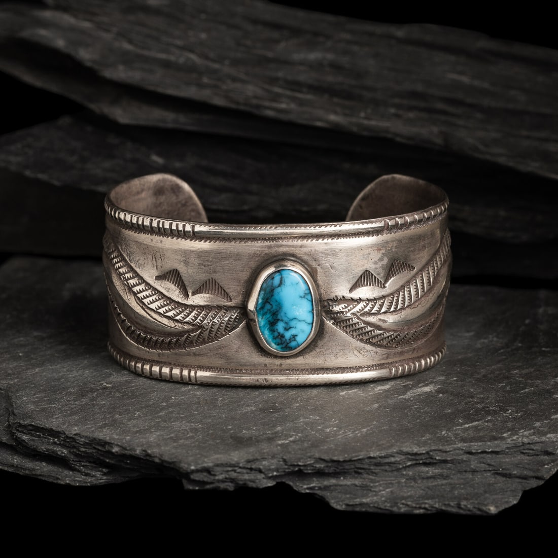 Navajo Ingot and Turquoise Cuff Bracelet: Navajo Ingot and Turquoise Cuff Bracelet 20th century not marked width 1-3/8 inches interior circumference 6-1/2 inches + gap length 1-1/8 inches weight 70.4 dwt. This lot is located in Chicago.