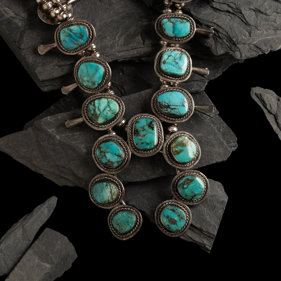 Navajo Silver and Turquoise Squash Blossom Necklace: Navajo Silver and Turquoise Squash Blossom Necklace third quarter 20th century not marked necklace length 12 inches naja length 3-3/4 inches x width 3-5/8 inches weight 123.5 dwt. This lot is located 