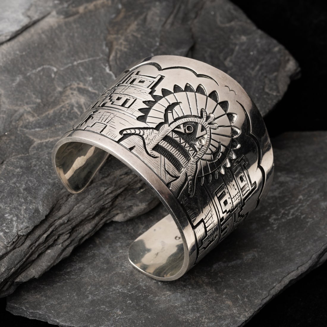 Victor Coochwytewa (Hopi, 1922-2011) Silver Overlay Katsina and Pueblo Cuff Bracelet: Victor Coochwytewa (Hopi, 1922-2011) Silver Overlay Katsina and Pueblo Cuff Bracelet marked with artist's raincloud hallmark and the figure shop mark for Kopoavi International Shop width 2 inches inte