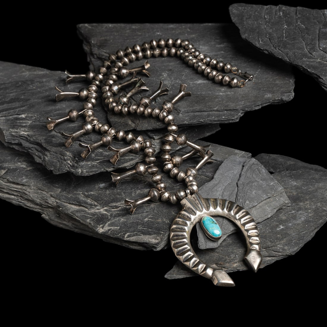 Sadie Randolph (DinÈ, 20th century) Silver and Turquoise Squash Blossom Necklace: Sadie Randolph (DinÈ, 20th century) Silver and Turquoise Squash Blossom Necklace marked with a scripted R length 26-1/2 inches naja length 3-1/8 inches x width 2-1/2 inches weight 67.4 dwt. This 