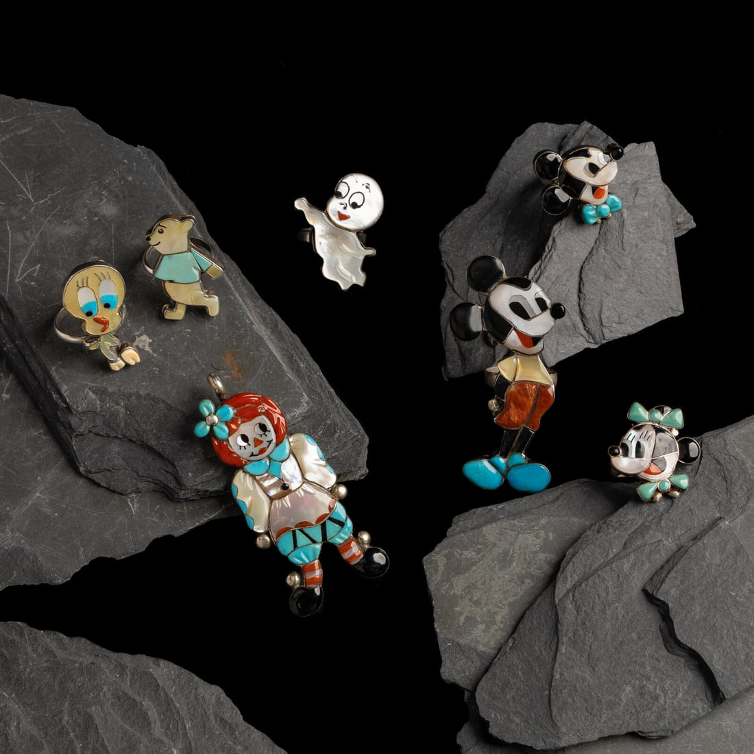 Collection of Mosaic Inlay Zuni-toon Rings and Pendant: Collection of Mosaic Inlay Zuni-toon Rings and Pendant second half 20th century lot of 7, includes: a Raggedy Ann pendant, signed VERONICA for Veronica Poblano (Zuni, 1951) length 2-3/4 inches x width