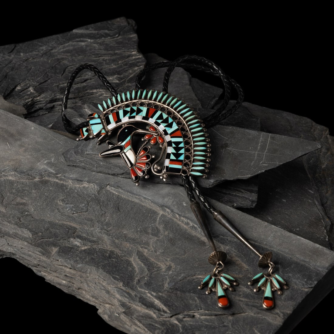 Benji Zuniga (Zuni, 20th century) Large Hummingbird and Rainbow Man Mosaic Inlay Bolo Tie, 1980: Benji Zuniga (Zuni, 20th century) Large Hummingbird and Rainbow Man Mosaic Inlay Bolo Tie, 1980 signed an dated on reverse slide length 4 inches x width 3-1/4 inches bolo length 30-1/2 inches total we