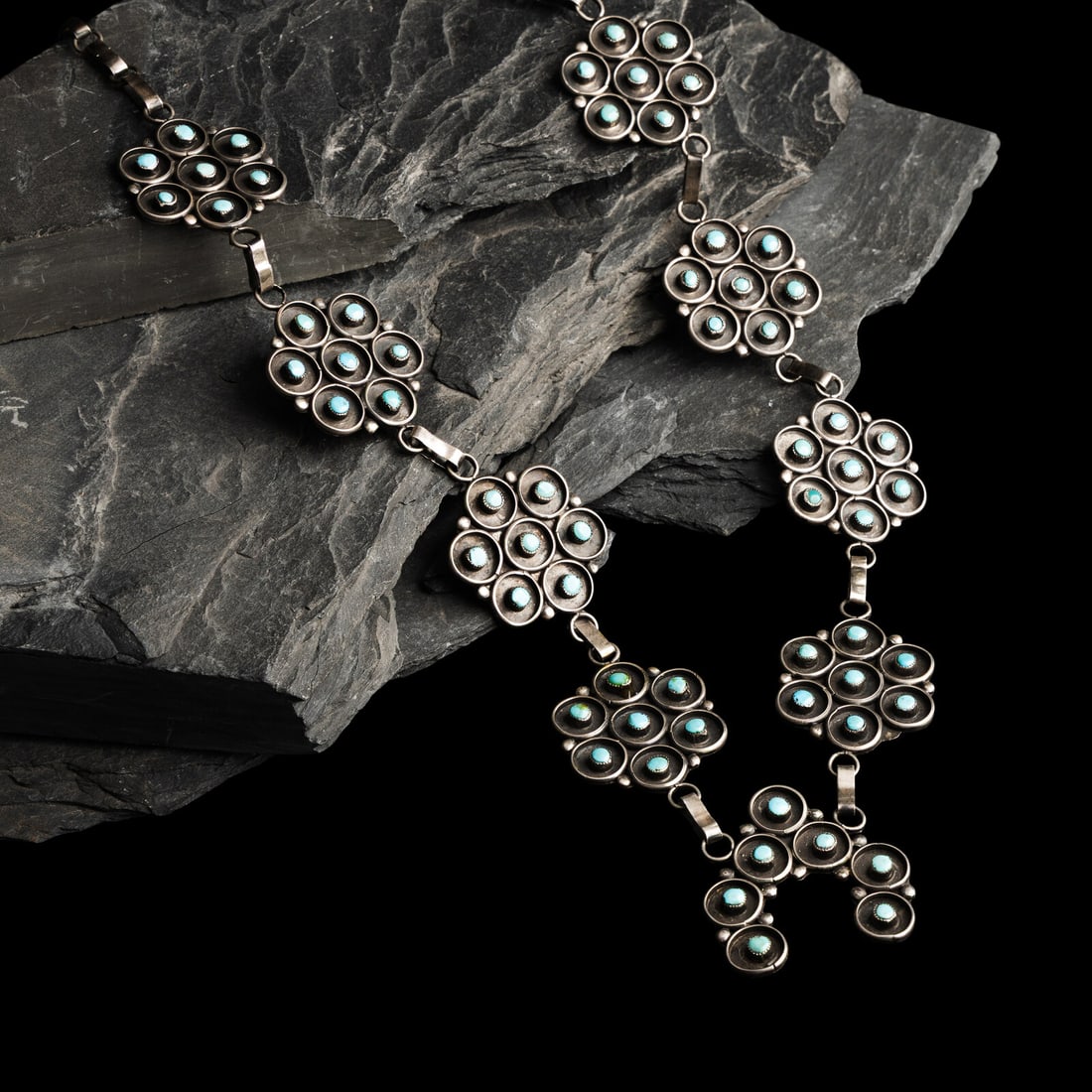 Navajo Silver and Petit Point Turquoise Squash Blossom Necklace: Navajo Silver and Petit Point Turquoise Squash Blossom Necklace third quarter 20th century not marked length 32-1/2 inches naja length 1-3/4 inches x width 1-1/2 inches weight 53.1 dwt. This lot is lo