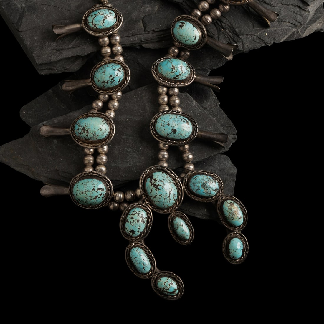 Large Navajo Silver and Turquoise Squash Blossom Necklace: Large Navajo Silver and Turquoise Squash Blossom Necklace third quarter 20th century eight squash blossoms and a large central naja; not marked length 25-1/2 inches naja length 3-1/2 inches x width 3-
