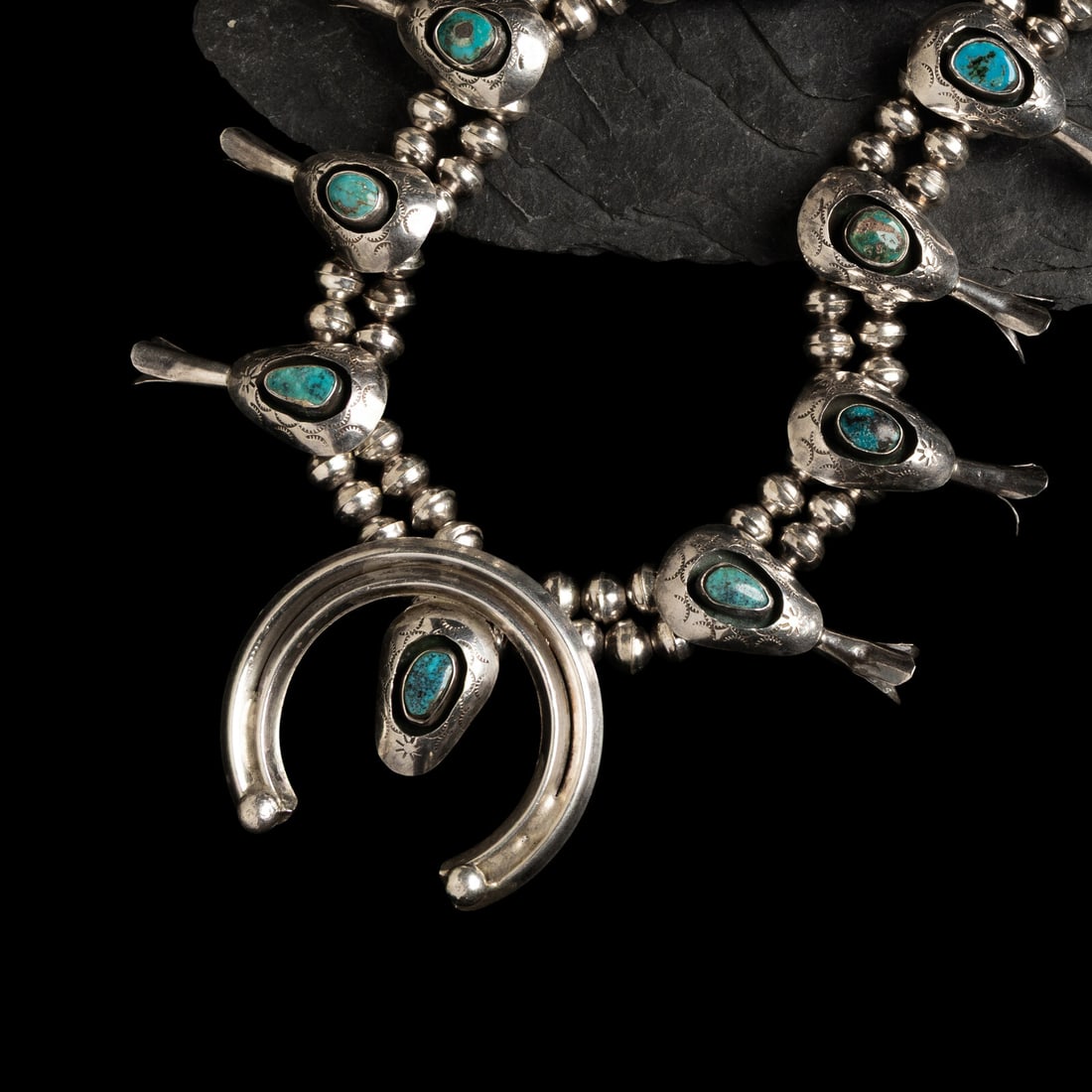 Navajo Silver and Turquoise Shadowbox Squash Blossom Necklace: Navajo Silver and Turquoise Shadowbox Squash Blossom Necklace third quarter 20th century not marked length 27 inches naja length 2 inches x width 2-1/8 inches weight 81.7 dwt. This lot is located in C