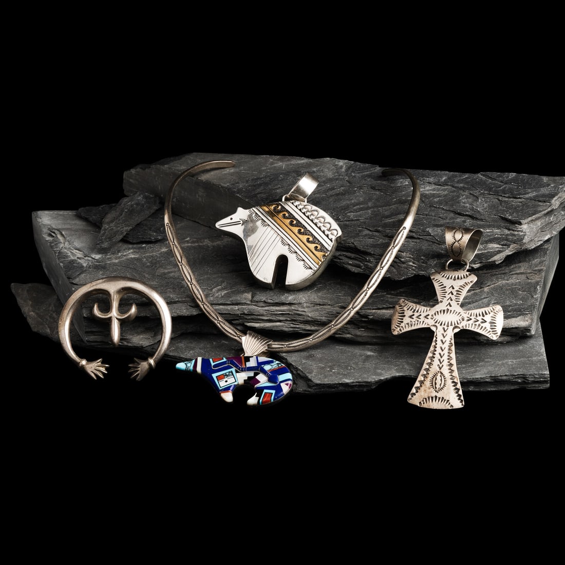 Navajo Pendants and Collar Necklace: Navajo Pendants and Collar Necklace second half 20th century lot of 4, includes: a stamped collar necklace, marked STERLINGHS length 10-1/2 inches weight 24.4 dwt. a silver and brass bear pendant; mar
