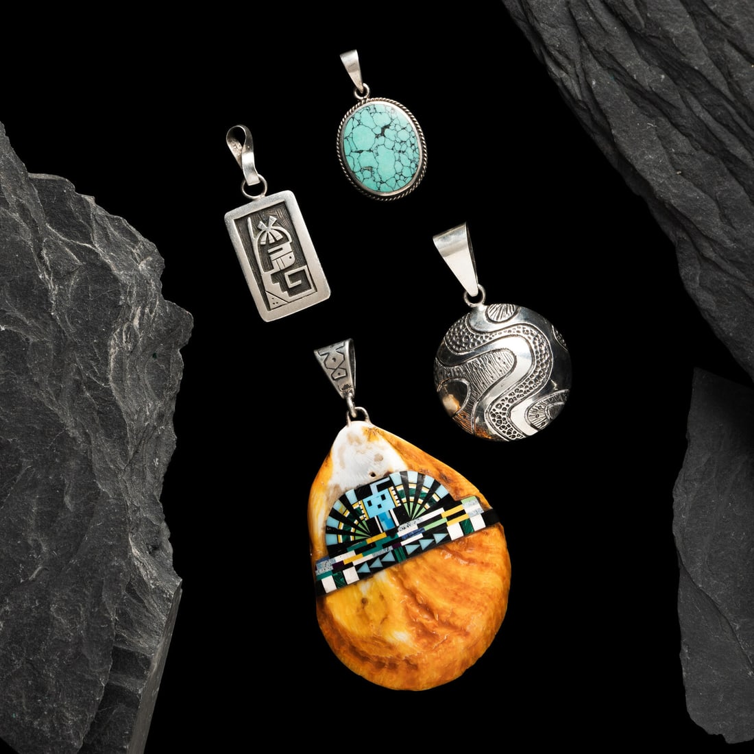 Navajo, Pueblo, and Hopi Pendants: Navajo, Pueblo, and Hopi Pendants late 20th - early 21st century lot of 4, includes: a silver pendant with swirling design; signed KEE for Kee Yazzie (DinÈ, b. 1969) length 2-1/8 inches x width 1