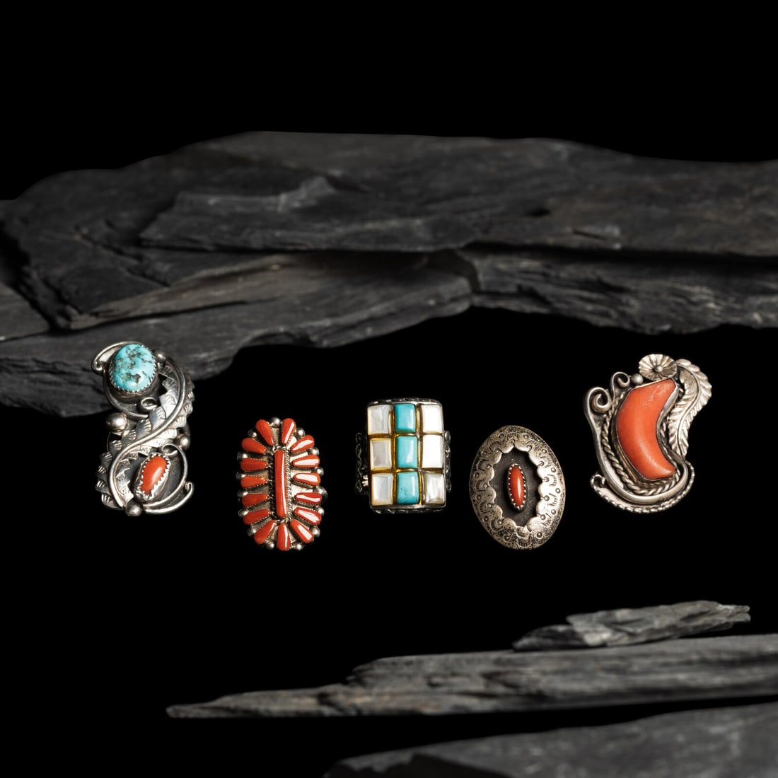 Navajo Silver Rings: Navajo Silver Rings mid - third quarter 20th century lot of 5, includes: an unmarked split shank ring set with turquoise and shell size 9.5 weight 8.5 dwt. one with coral and turquoise; marked DDC