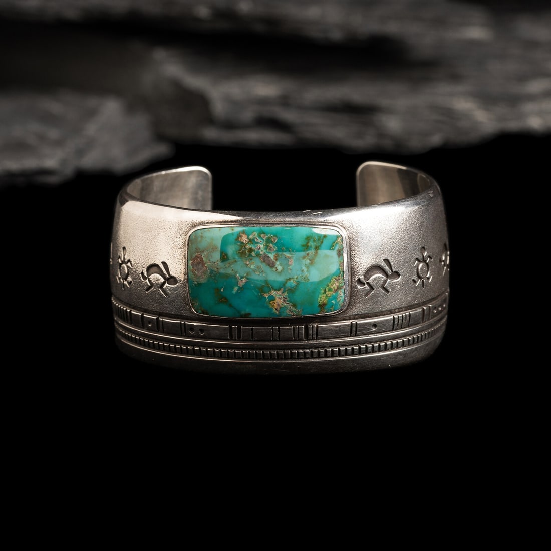 Norbert Peshlakai (DinÈ, b. 1953) Silver and Turquoise Cuff Bracelet, with Rabbits: Norbert Peshlakai (DinÈ, b. 1953) Silver and Turquoise Cuff Bracelet, with Rabbits marked with artist's hallmark on terminal width 1-3/16 inches interior circumference 5-1/2 inches + gap length 1