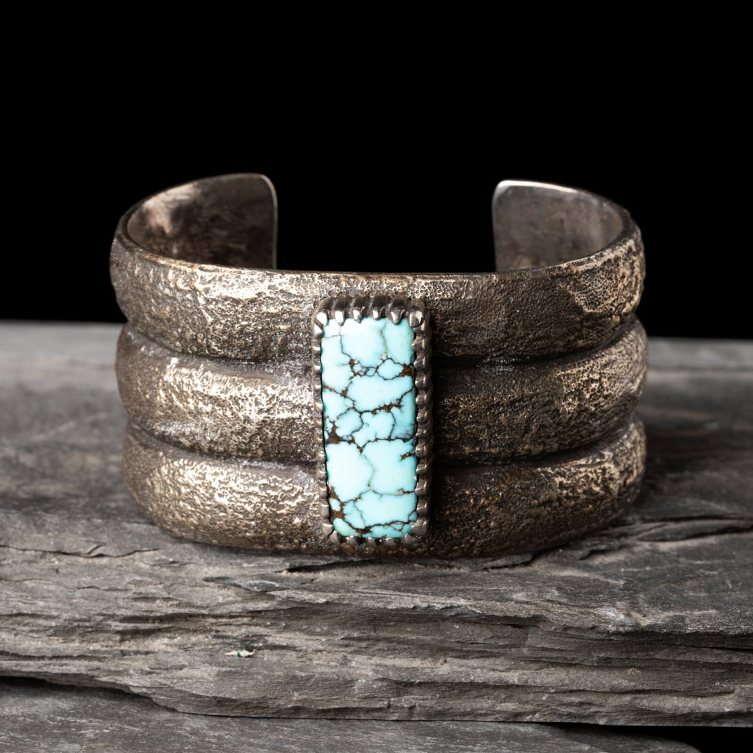 Mitchell Calabaza (Kewa, b. 1959) Tufa Cast Silver and Turquoise Cuff Bracelet: Mitchell Calabaza (Kewa, b. 1959) Tufa Cast Silver and Turquoise Cuff Bracelet marked CLBZ width 1-3/8 inches interior circumference 5 inches + gap length 1 inch weight 76.6 dwt. The Collection of Rob
