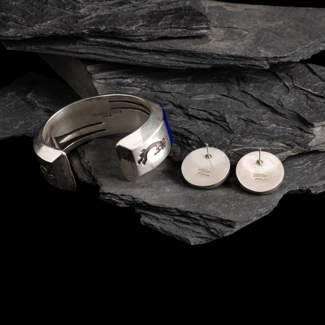 Michael L. Slim AND Knifewing Segura (DinÈ, act. since 1980s) AND (Chiricahua Apache, 20th: Michael L. Slim AND Knifewing Segura (DinÈ, act. since 1980s) AND (Chiricahua Apache, 20th century) Sterling Silver and Lapis Cuff Bracelet and Post Earrings lot of 2, includes: cuff with channel
