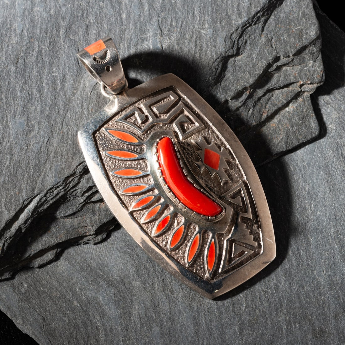 Michael Perry (DinÈ, b. 1972) Sterling Silver and Coral Pendant: Michael Perry (DinÈ, b. 1972) Sterling Silver and Coral Pendant marked MP STERLING length 3-3/4 inches x width 1-7/8 inches weight 52.0 dwt. Property from the Collection of Robert P. Hunter, Jr. 