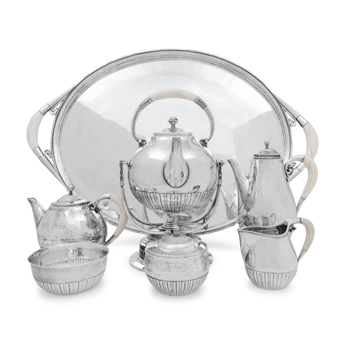 A Georg Jensen Cosmos Seven-Piece Silver Tea and Coffee Service: A Georg Jensen Cosmos Seven-Piece Silver Tea and Coffee Service Designed by Johan Rohde, Circa 1930s comprising a teapot, coffee pot, kettle-on-stand, covered sugar, creamer, waste bowl, and serving t