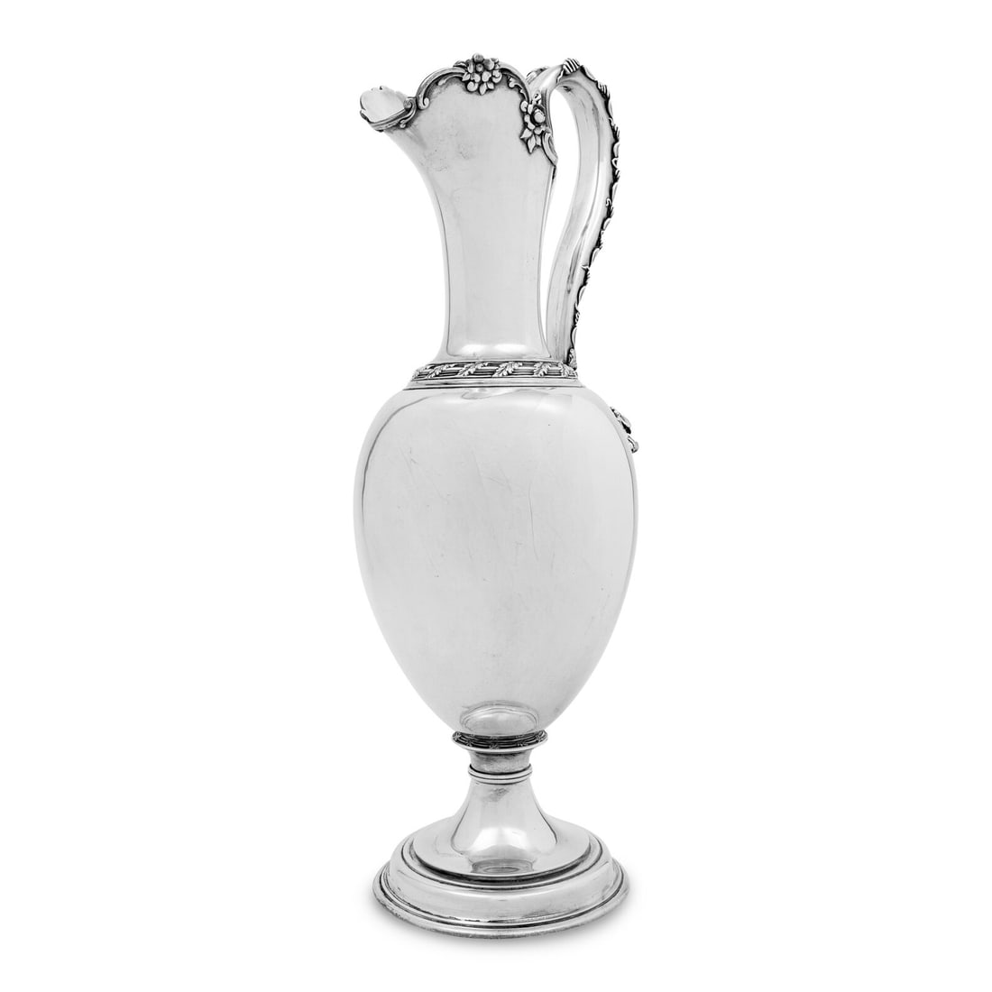 A Tiffany and Co. Silver Wine Ewer: A Tiffany and Co. Silver Wine Ewer New York, NY, Circa 1875 with a foliate handle terminating in a Bacchic mask; marked 'Tiffany & Co./Makers/Sterling Silver' to underside; further marked with pat