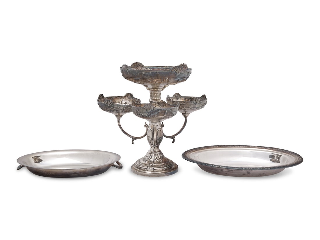 A Silver Repousse Epergne: A Silver Repousse Epergne Likely 20th Century the epergne possibly Anglo-Indian and likely .750 silver purity, with four tiered compotes, with repousse decoration depicting hunters and animals includi