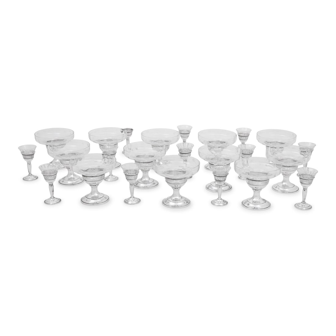 An American Silver Mounted Cut Glass Stemware Service: An American Silver Mounted Cut Glass Stemware Service Redlich and Co., New York, NY, 20th Century comprising 12 coupes and 11 cordials; together with one additional cordial stem lacking its glass bowl