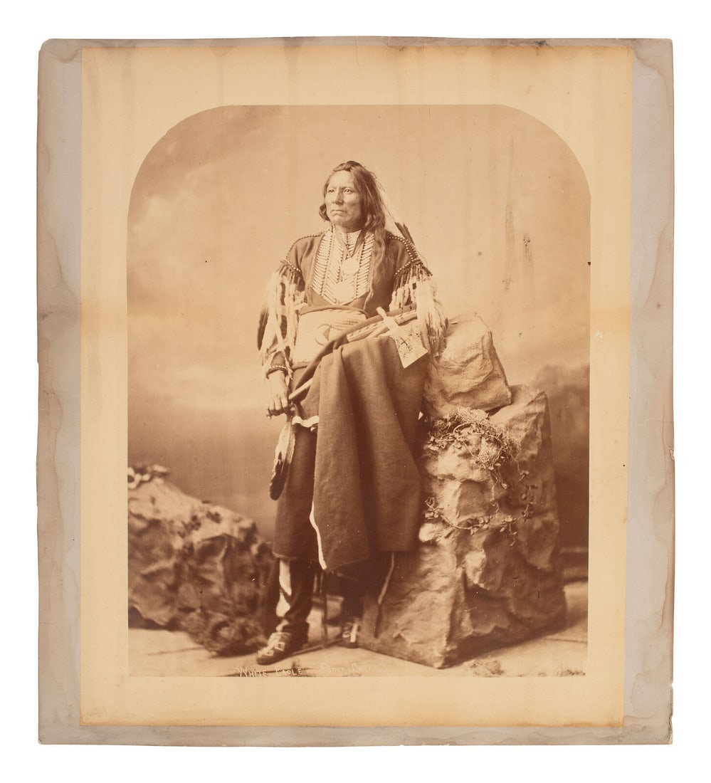 [Native-Americana] Bell, Charles M. White Eagle, Ponca Chief, ca. 1877: [Native-Americana] Bell, Charles M. White Eagle, Ponca Chief, ca. 1877 Washington, D.C., ca. 1877. Mammoth plate albumen photograph on original card; 20 x 18 in. (508 x 457 mm). Scattered foxing and s