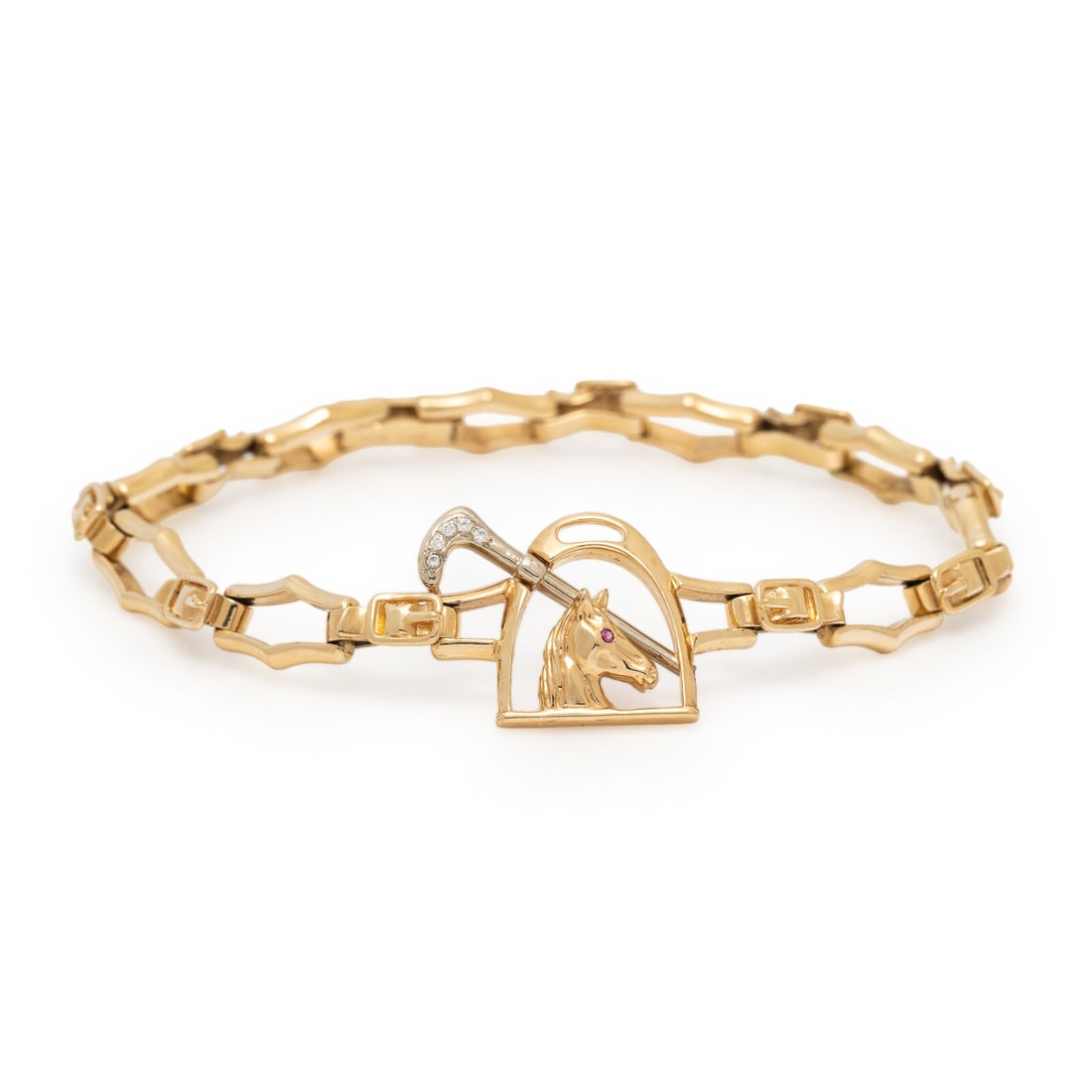 Diamond and Yellow Gold Equestrian Bracelet: Diamond and Yellow Gold Equestrian Bracelet Round diamonds and one round ruby. 14 karat yellow and white gold. 9 inches long. Stamp: 14K (maker's mark). Gross weight: 18.85 dwt. Property from the