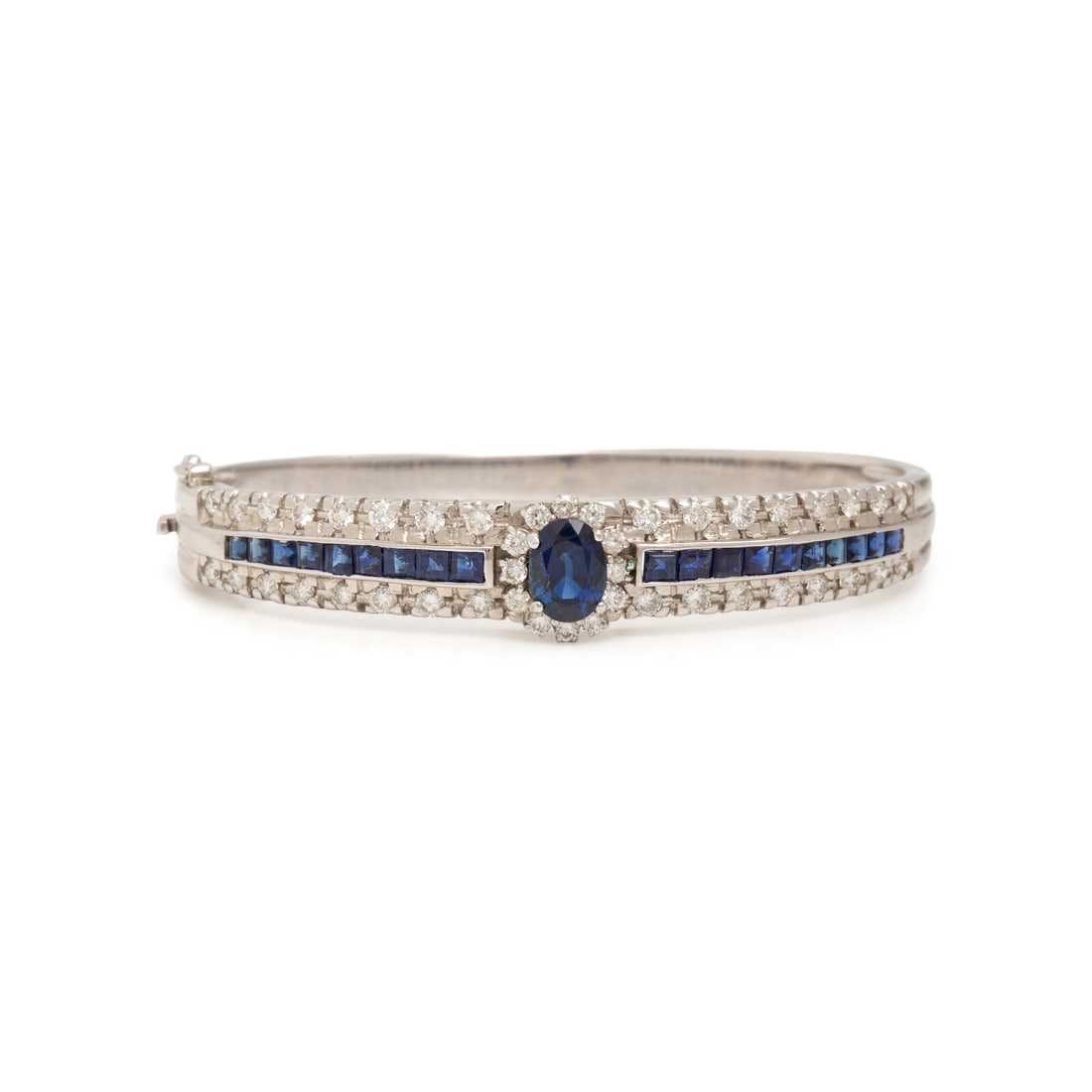 White Gold, Sapphire, and Diamond Bangle Bracelet: White Gold, Sapphire, and Diamond Bangle Bracelet Oval sapphire weighing approximately 1.85 carats by formula, square step-cut sapphires, and round diamonds weighing approximately 2.15 carats total,