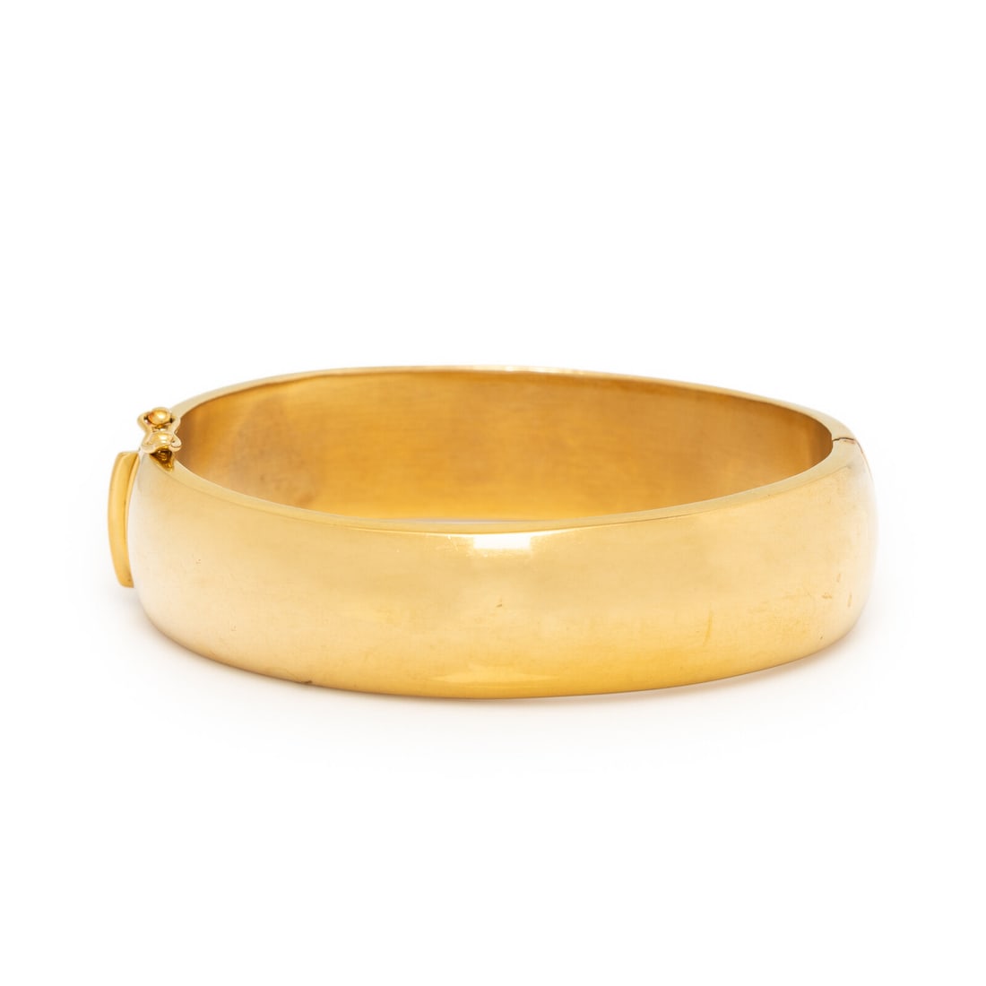 Ceta?, Yellow Gold Bangle Bracelet: Ceta?, Yellow Gold Bangle Bracelet Hinged with side clasp. 18 karat yellow gold. 6 7/8 inches inner circumference. Stamp: 750 (partially obscured) CETA?. Gross weight: 27.50 dwt. Property of a