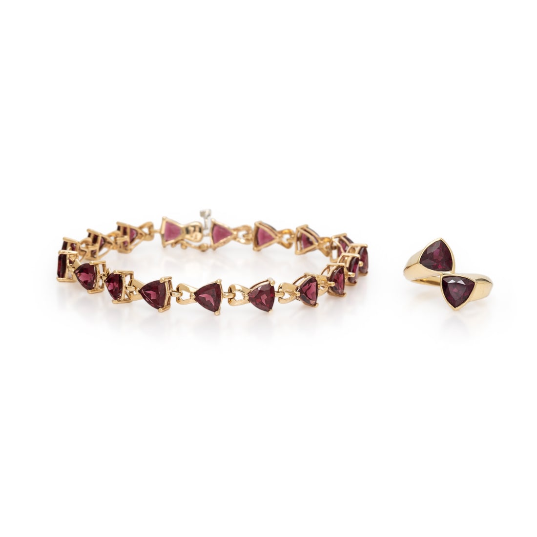 Yellow Gold and Garnet Demi Parure: Yellow Gold and Garnet Demi Parure Including a bracelet and ring each set with trillion cut garnets. 14 karat yellow gold. Ring size 5 3/4. Bracelet: 7 3/4 inches long. Ring stamp: STS 14K. Bracelet