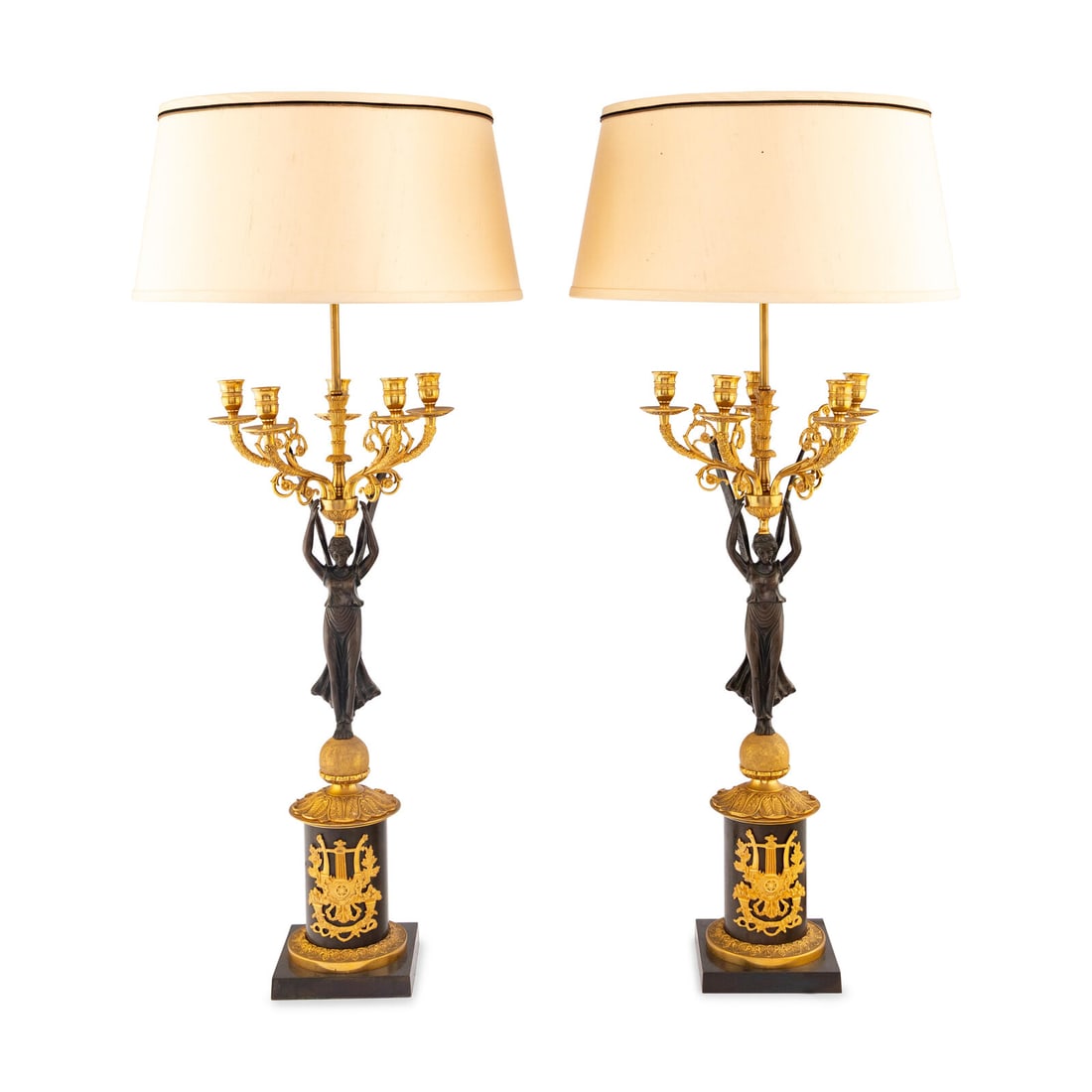 A Pair of Empire Style Gilt and Patinated Bronze Candelabra Mounted as Lamps: A Pair of Empire Style Gilt and Patinated Bronze Candelabra Mounted as Lamps 20th Century Height overall 37 inches. Property from Strawberry Hill: The Collection of Ada and Barrie Regan,