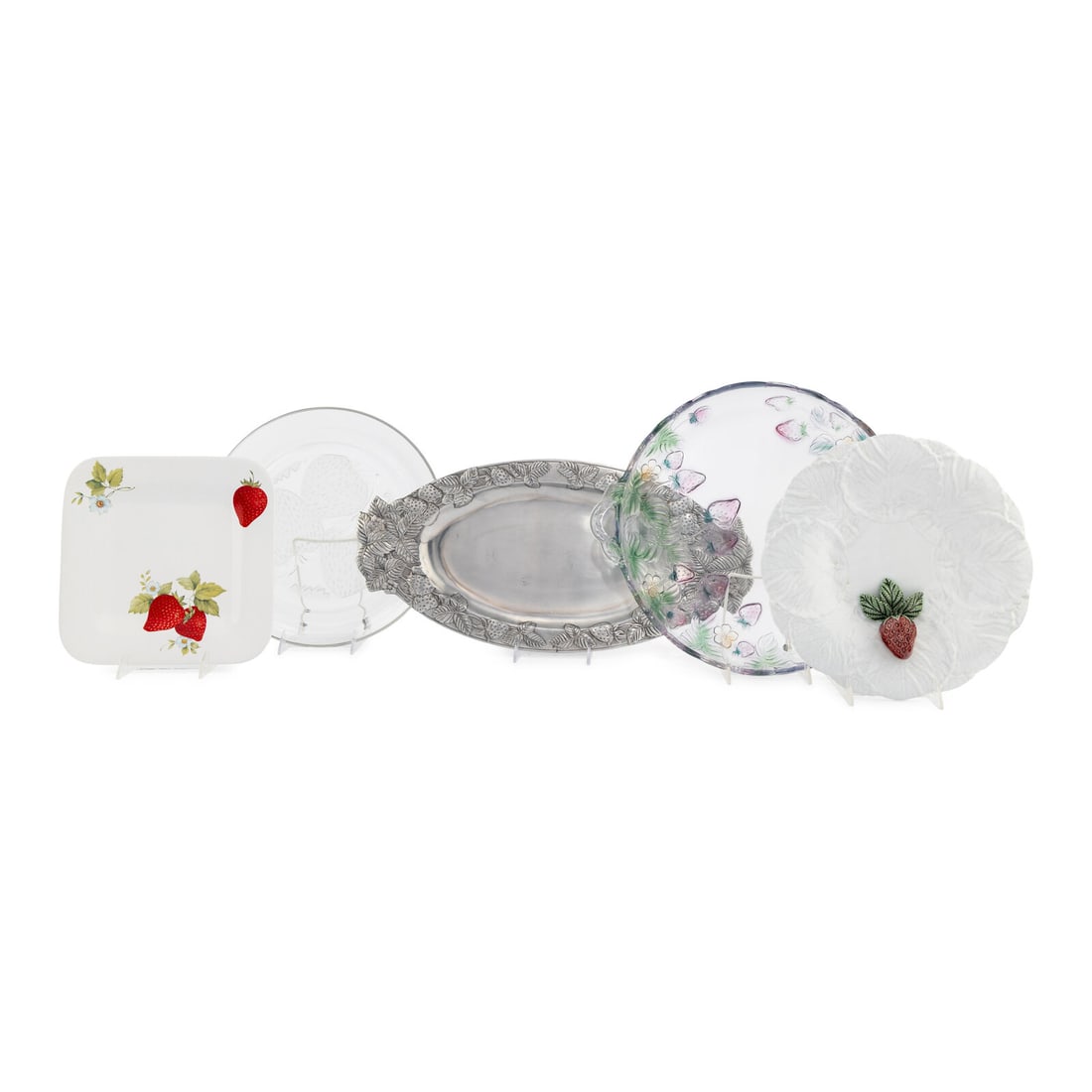 A Group of Strawberry Themed Serving Platters: A Group of Strawberry Themed Serving Platters comprising two ceramic examples, two glass examples, and one pewter example; 5 items total. Length of largest example 21 inches. Property from Strawberry