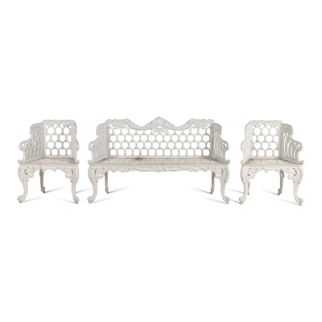 A White-Painted Cast Iron Three-Piece Garden Seating Suite: A White-Painted Cast Iron Three-Piece Garden Seating Suite comprising a settee and a pair of armchairs. Height of settee 37 x width 63 x depth 18 1/2 inches; height of armchair 35 x width 28 x depth