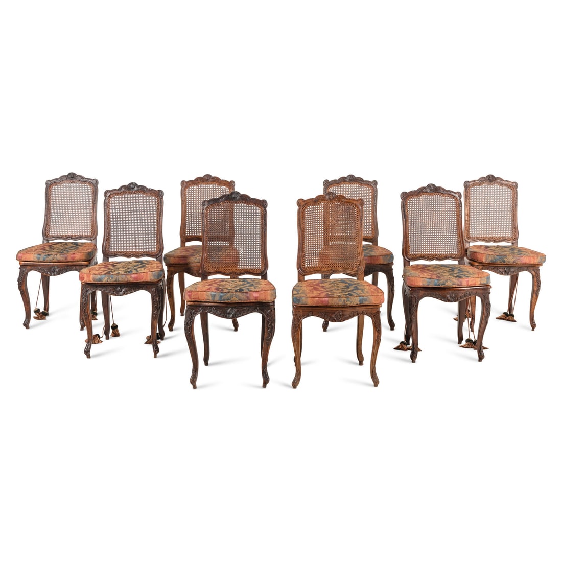 A Set of Eight French Carved Walnut and Caned Dining Chairs: A Set of Eight French Carved Walnut and Caned Dining Chairs Four 18th Century, Four 19th Century Height 40 x width 19 1/2 x depth 17 inches. This lot is located in Chicago.
