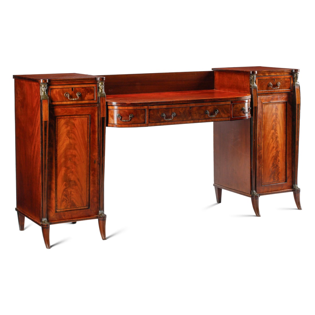 A Regency Gilt Bronze Mounted Mahogany Sideboard: A Regency Gilt Bronze Mounted Mahogany Sideboard 19th Century and Later the central drawer opening to a writing surface. Height 43 x width 84 x depth 25 inches. This lot is located in Chicago.