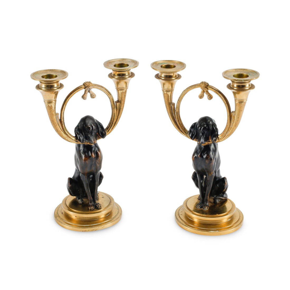A Pair of Gilt and Patinated Bronze Dog Motif Two-Light Candelabra: A Pair of Gilt and Patinated Bronze Dog Motif Two-Light Candelabra Late 19th/Early 20th Century Height 9 1/4 x width 6 1/2 x depth 4 inches. This lot is located in Chicago.
