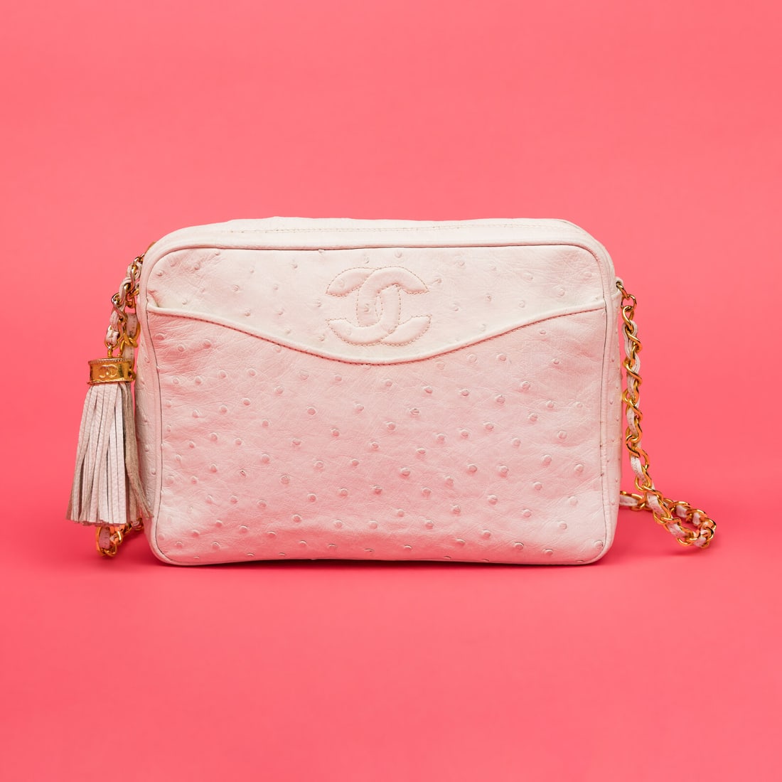 Chanel, Camera Bag in White Ostrich: Chanel, Camera Bag in White Ostrich Camera bag in white ostrich leather with gold-tone hardware. Zipper closure and interwoven leather-metal chain strap. Label: Chanel Style/Serial No.: 0527796 Date: 