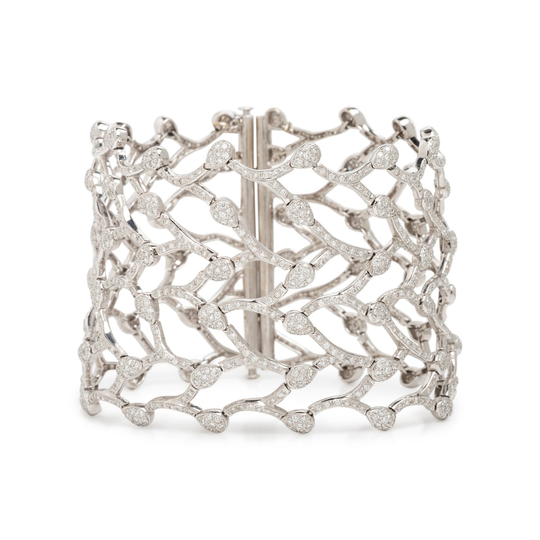 White Gold and Diamond Bracelet: White Gold and Diamond Bracelet Round brilliant cut diamonds weighing approximately 7.20 carats total, with a flexible construction. 18 karat white gold. 7 inches inner circumference, 2 inches wide. S