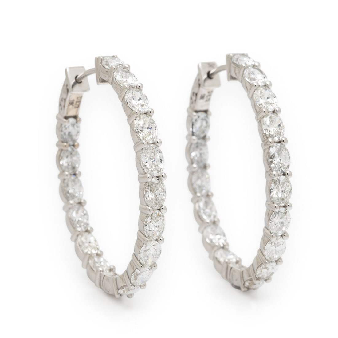 Diamond and White Gold Inside Out Oval Hoop Earrings: Diamond and White Gold Inside Out Oval Hoop Earrings Oval diamonds weighing approximately 8.73 carats total. 18 karat white gold. 1 3/8 x 1 1/8 inches. Stamp: D 8.73 18K. Gross weight: 9.45 dwt. This 