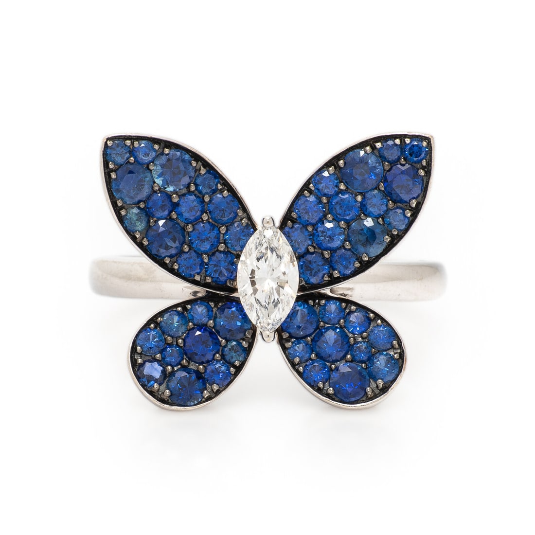 Graff, Diamond, Sapphire, and White Gold Butterfly Ring: Graff, Diamond, Sapphire, and White Gold Butterfly Ring Marquise cut diamond weighing approximately 0.25 carat, and wings pavÈ set with blue sapphires. 18 karat white and blackened gold. Ring siz