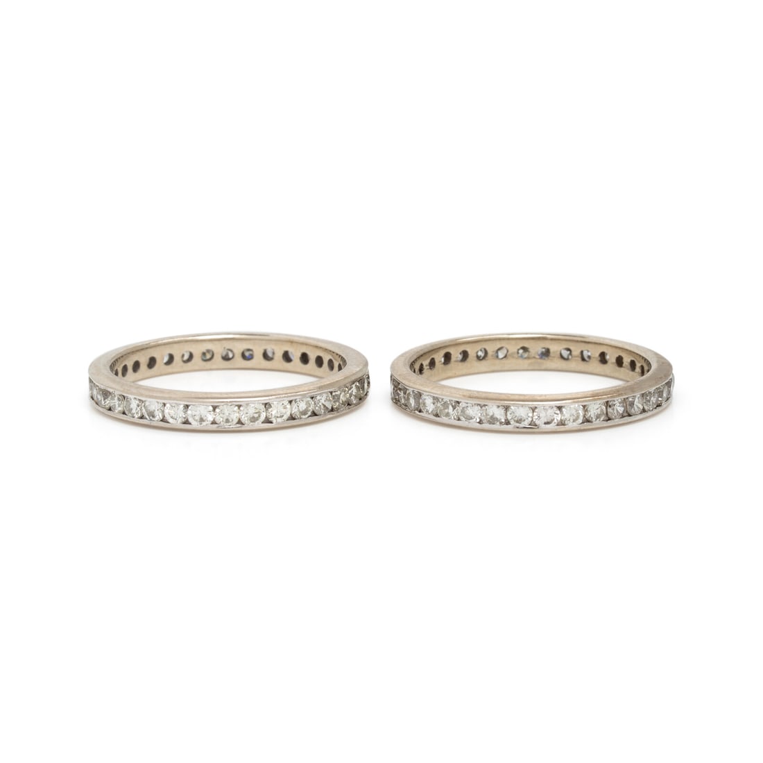 Pair of Diamond and White Gold Eternity Bands: Pair of Diamond and White Gold Eternity Bands Channel-set round brilliant cut diamonds weighing approximately 1.45 carats total. White Gold. Ring 6 3/4. Gross weight: 2.65 dwt. Property from a Naples,