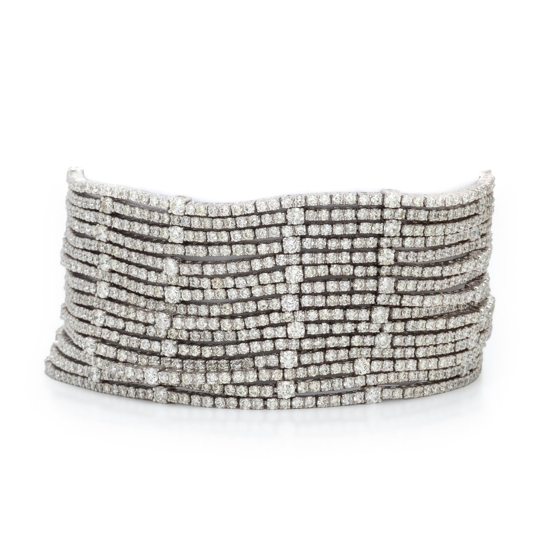 Diamond and White Gold Multistrand Bracelet: Diamond and White Gold Multistrand Bracelet Round brilliant cut diamonds weighing approximately 16.00 - 18.00 carats total. 18 karat white gold. 7 inches long, 1 1/8 inches wide. Stamp: 18K. Gross wei