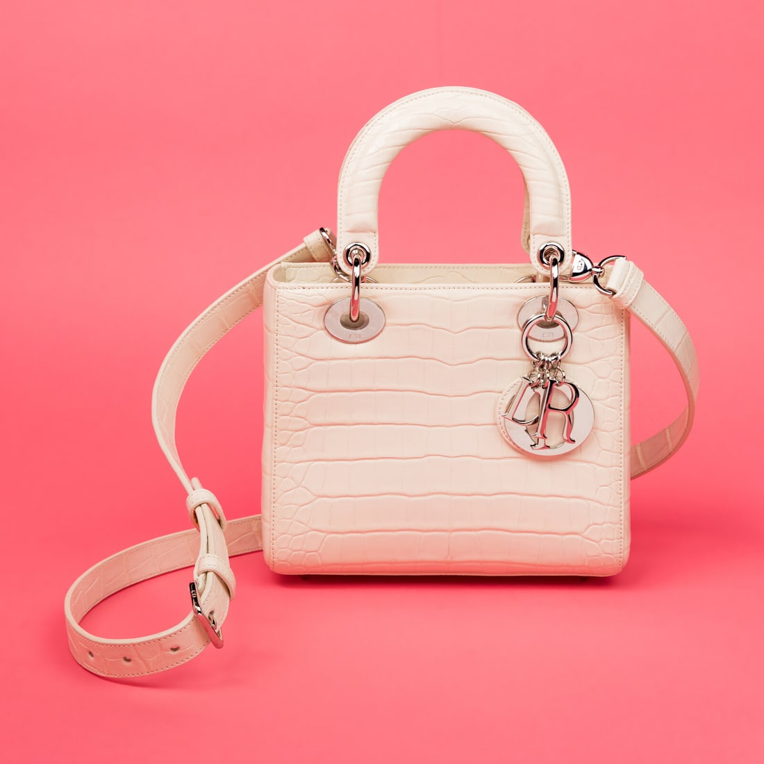 Christian Dior, Small Lady Dior in Off-White Alligator: Christian Dior, Small Lady Dior in Off-White Alligator Small Lady Dior bag in off-white alligator skin with silver-tone hardware. Magnetic snap closure and flat alligator strap/handle. Label: Christia