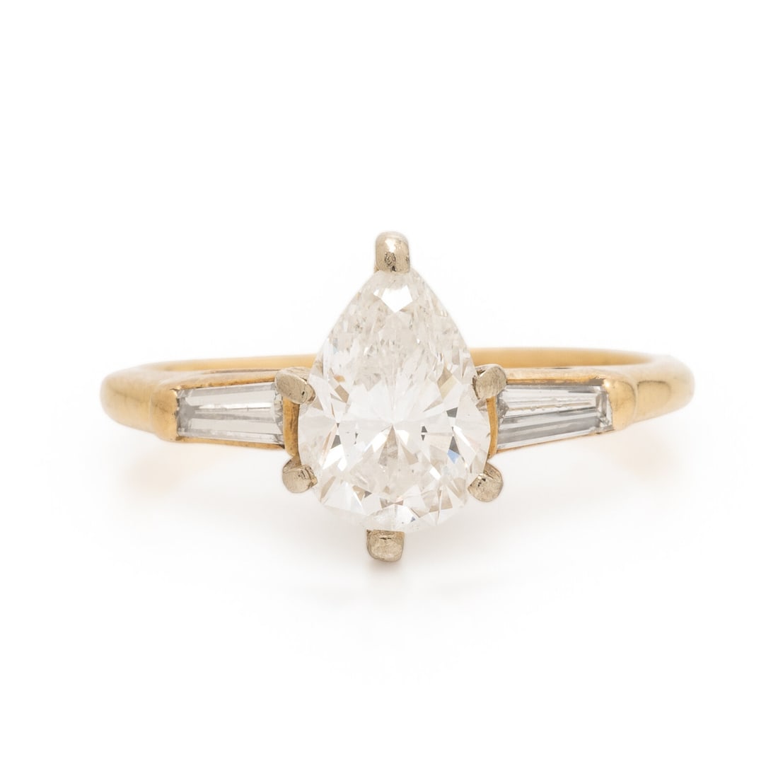 Diamond and Yellow Gold Ring: Diamond and Yellow Gold Ring Pear shape diamond weighing approximately 1.02 carats, with tapered baguette cut diamonds weighing approximately 0.15 carat total. Yellow gold. Ring size 4 1/2. Gross weig