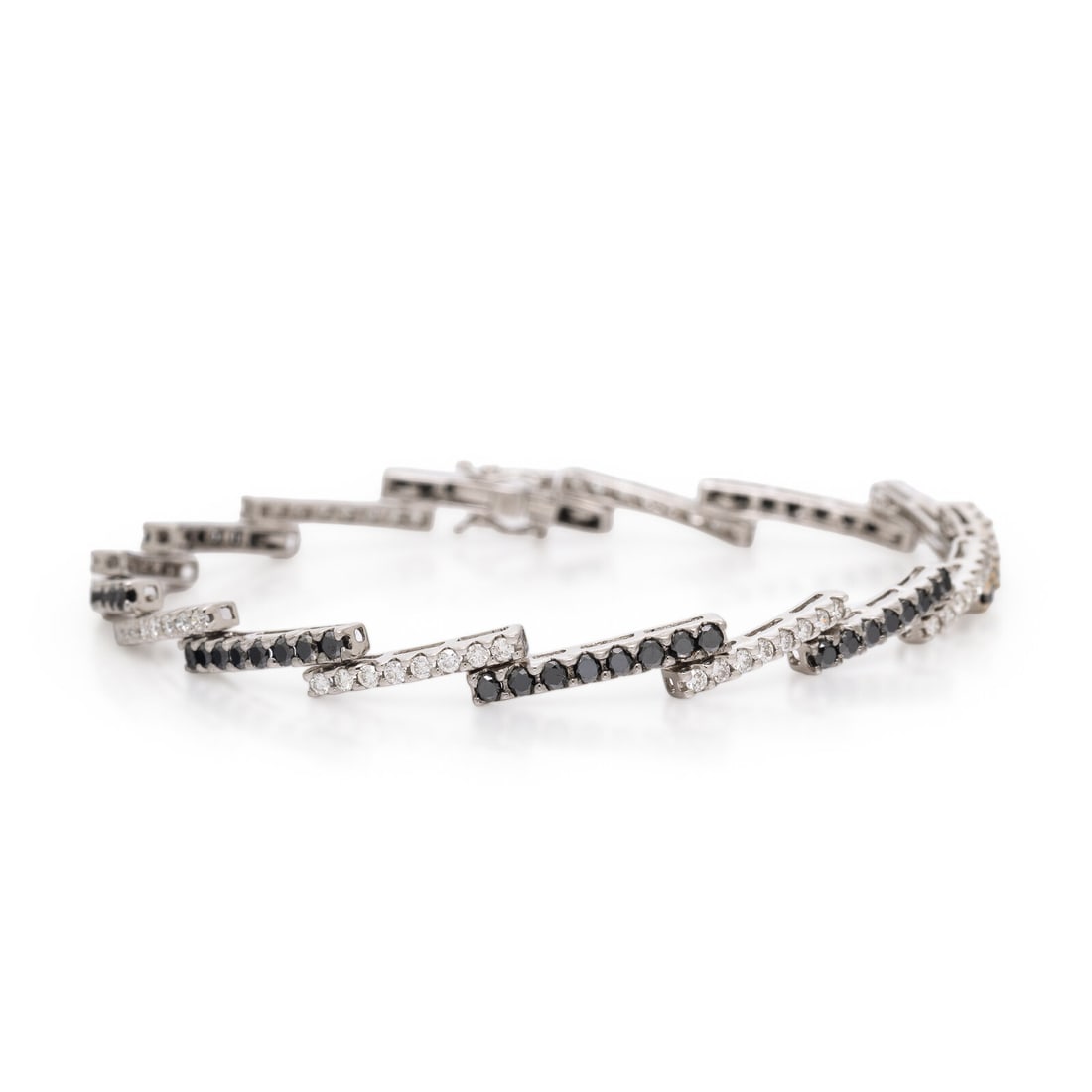 Diamond, Black Diamond, and White Gold Bracelet: Diamond, Black Diamond, and White Gold Bracelet Round brilliant cut diamonds weighing approximately 0.75 carat total, and black diamonds. 18 karat white gold. 7 1/4 inches long. Stamp: 18K. Gross weig