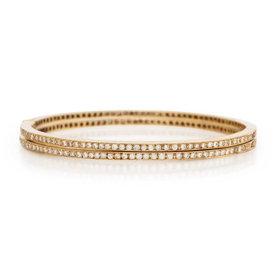 Pair of Diamond and Yellow Gold Bangle Bracelets: Pair of Diamond and Yellow Gold Bangle Bracelets Set throughout with round brilliant cut diamonds weighing approximately 2.90 carats total, hinged with side clasps. Yellow gold. 7 inches inner circumf