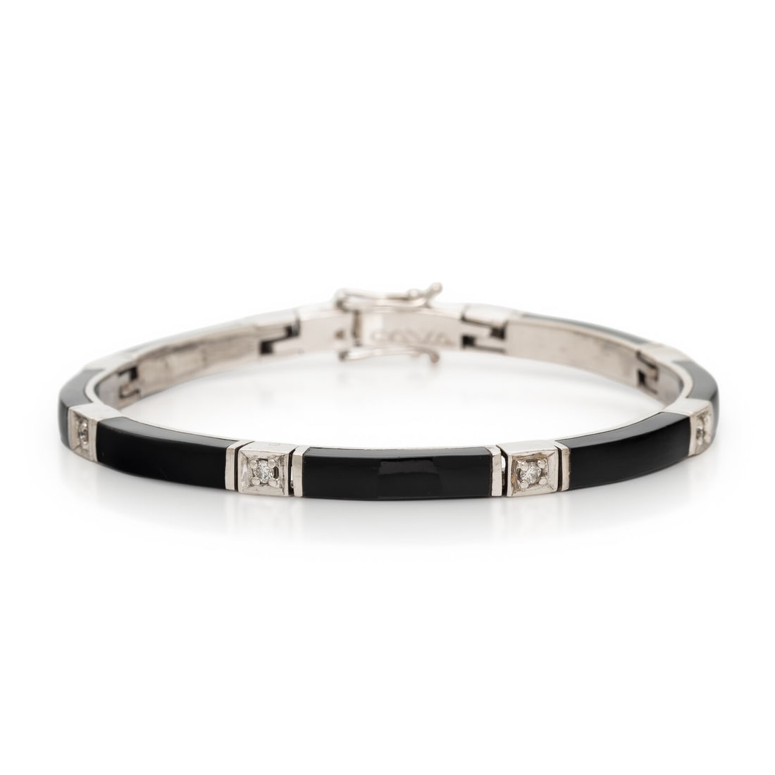 Onyx, Diamond, and White Gold Bracelet: Onyx, Diamond, and White Gold Bracelet Onyx plaques, and round brilliant cut diamonds weighing approximately 0.20 carat total. 18 karat white gold. 6 3/4 inches long. Stamp: 18K. Engraved: (partially