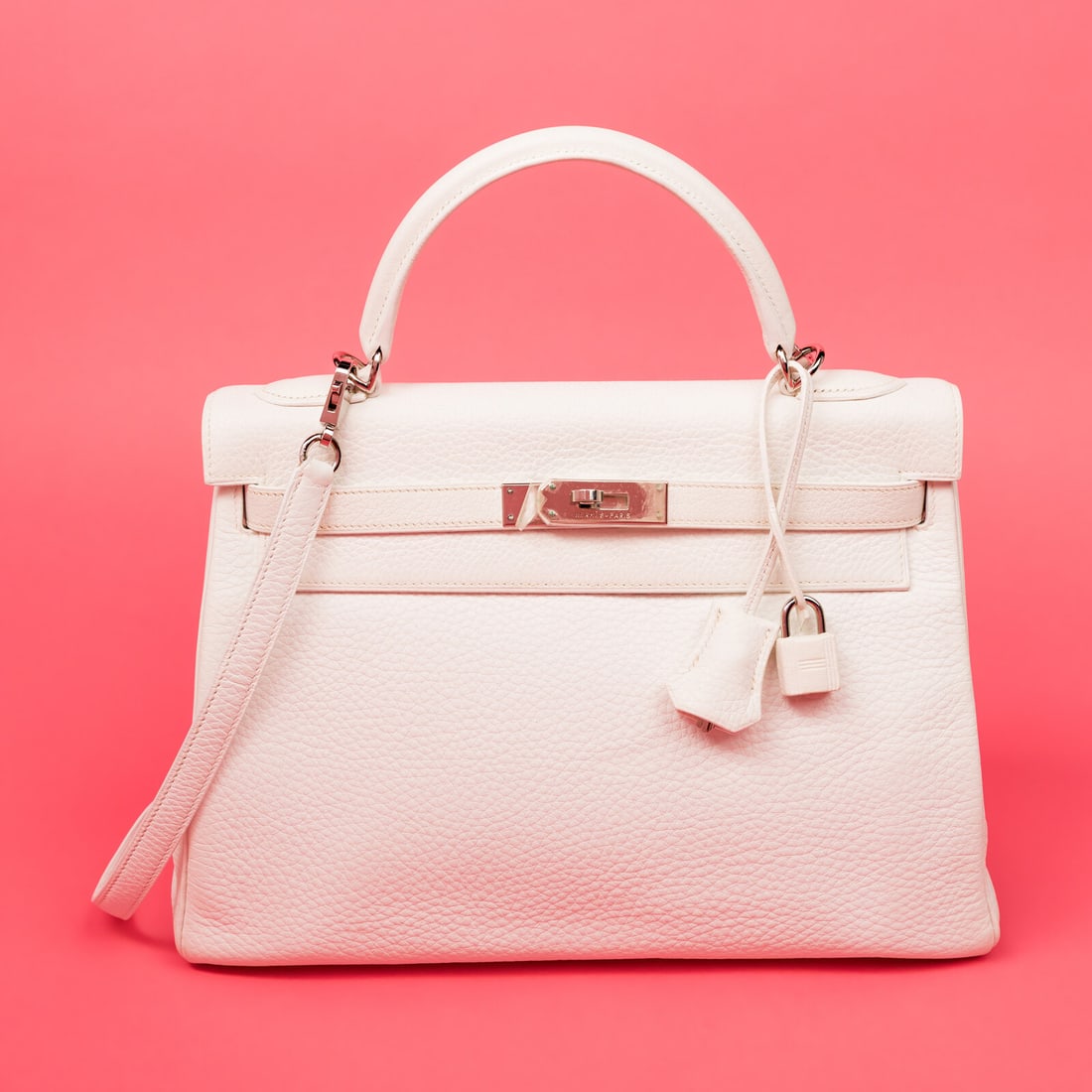 Hermès, Kelly Retourne 32 in White Clemence, 2004: Hermès, Kelly Retourne 32 in White Clemence, 2004 Kelly Retourne 32 in White Clemence Calfskin Leather with palladium-plated hardware. Label: Hermès Code: H Inside Square Date: 2004 Country of Origi