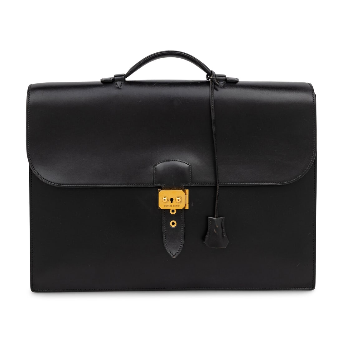 Hermès, Vintage Briefcase in Noir Box Leather: Hermès, Vintage Briefcase in Noir Box Leather Briefcase in Noir Box leather with gold-plated hardware. Locking push-lock clasp closure and leather top handle. Label: Hermès Stamp: A in Circle Date: 