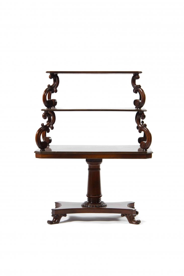 An English Mahogany Etagere, Height 39 1/2 inches.: An English Mahogany Etagere, having three graduated rectangular tiers with canted corners joined by S-scroll supports, raised on a ring turned columnar standard over a quadripartite base ending in car