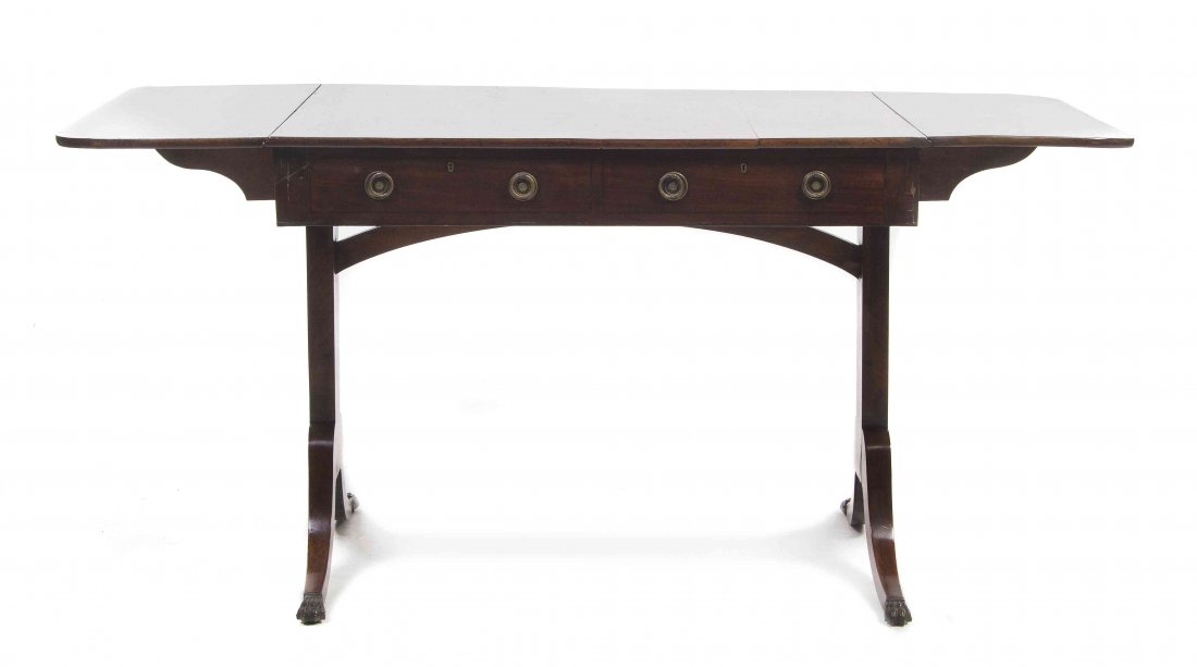 A Regency Mahogany Sofa Table, Height 27 1/2 x width 58: A Regency Mahogany Sofa Table, having a rectangular top over two rectangular leaves with rounded corners, fitted with two drawers, raised on twin supports ending in brass caps. Height 27 1/2 x width 5