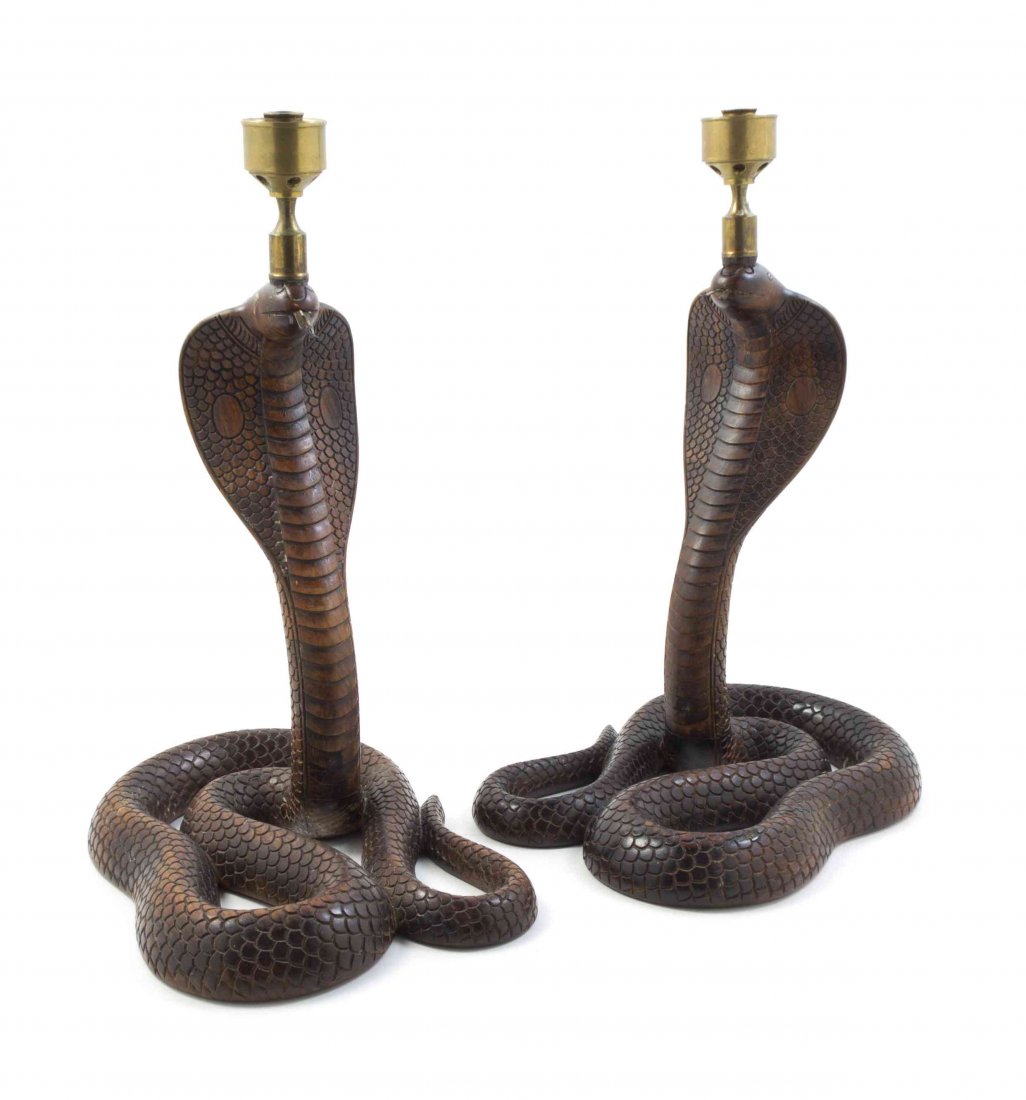 A Pair of Eastern Indian Rosewood Figural Candlesticks,: A Pair of Eastern Indian Rosewood Figural Candlesticks, each depicting a standing cobra. Height overall 19 inches. Property from the Collection of John Robert Wiltgen, Chicago, Illinois