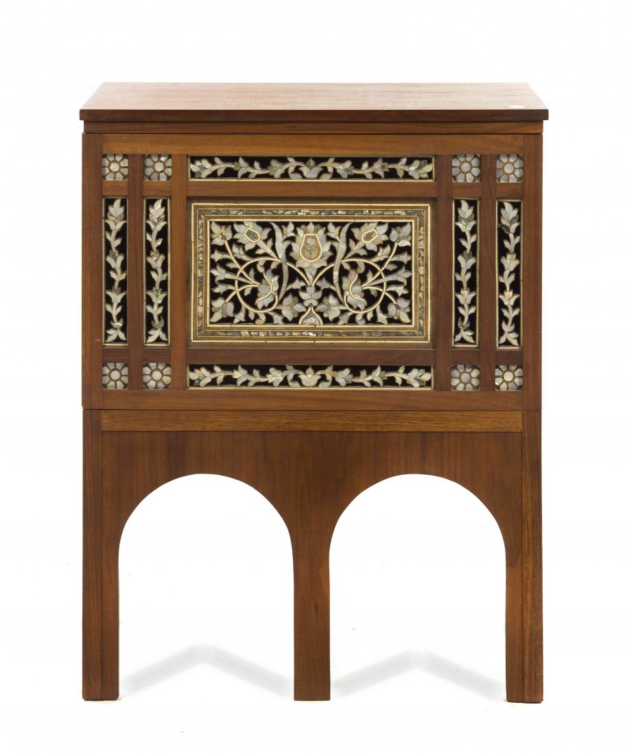 A Turkish Ottoman Mother-of-Pearl Inset Cabinet, Height: A Turkish Ottoman Mother-of-Pearl Inset Cabinet, having a rectangular top over the pierced carved foliate decorated door with applied abalone and mother-of-pearl decoration, raised on twin arch form l