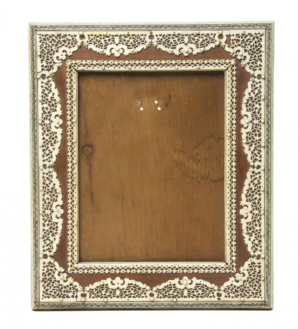 A Middle Eastern Ivory Mounted Frame, Height 12 3/8 x: A Middle Eastern Ivory Mounted Frame, of rectangular form, having pierced scrolling foliate decoration, further set with floral decorated ivory veneers. Height 12 3/8 x width 10 1/2 inches.